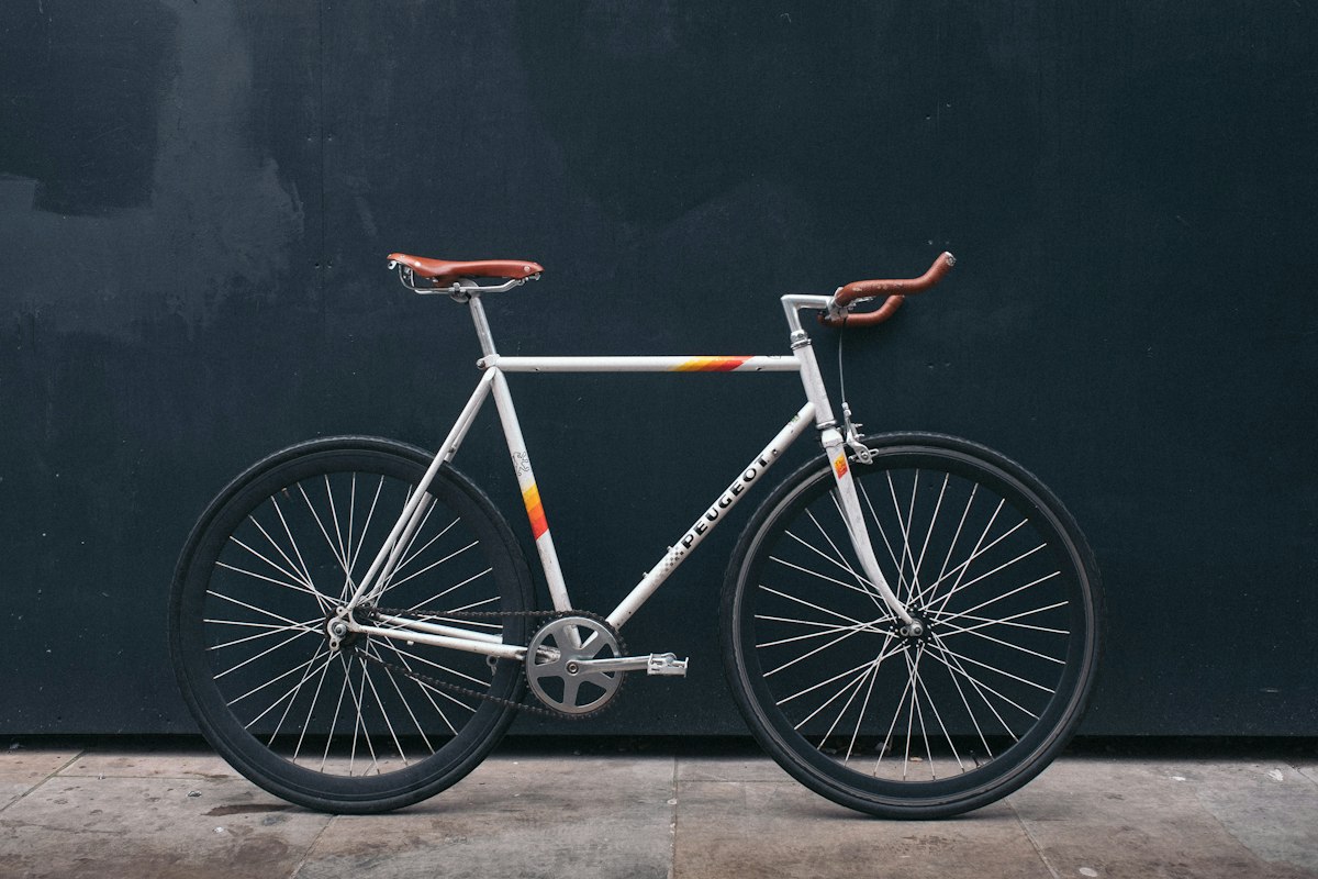 White road bicycle against a dark wall